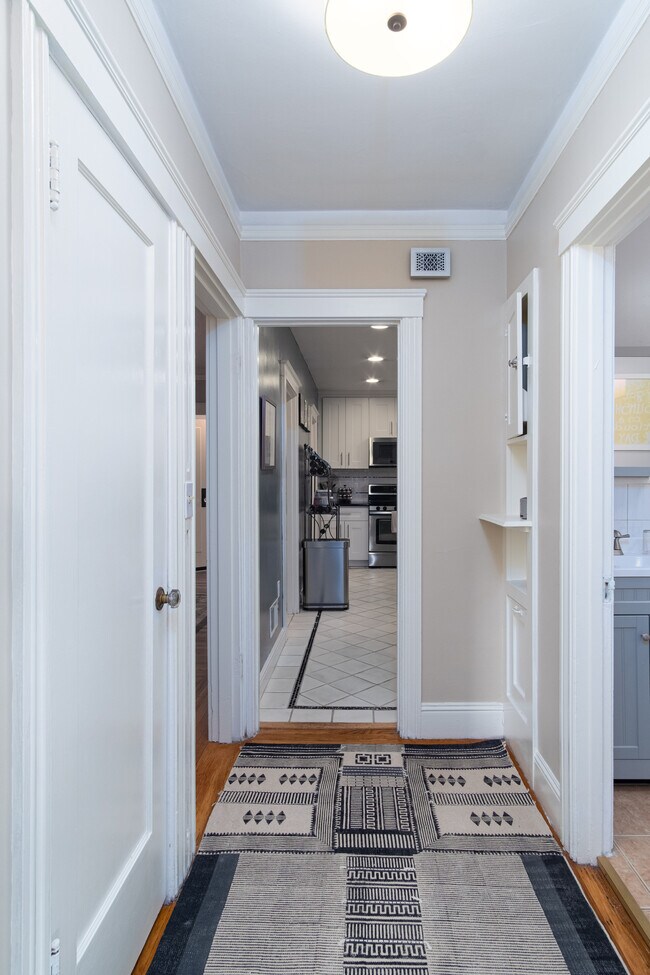 Hallway with coat closet and linen closet - 1211 34th Ave