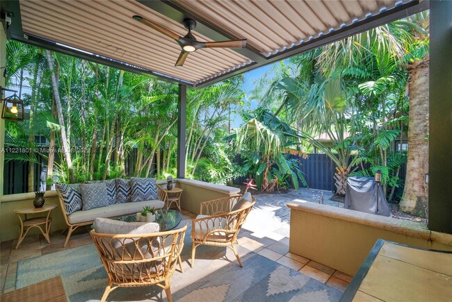 Elevated patio with remote controlled sun roof overlooks lush landscaping with 6' privacy fence to c - 1109 NE 3rd St