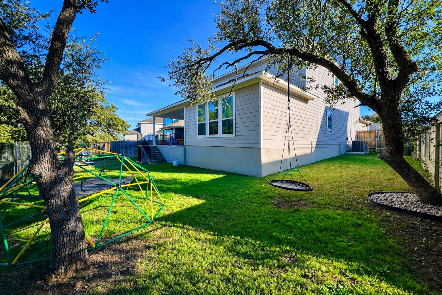 Spacious backyard with large side yards, offering plenty of room to play and relax. - 517 Moonlit Stream Pass