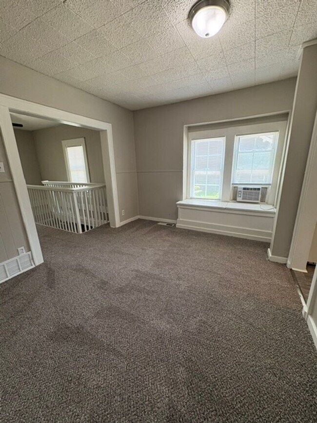 Building Photo - A cozy 2 bedroom home with versatile living space and plenty of storage including a partially fin...
