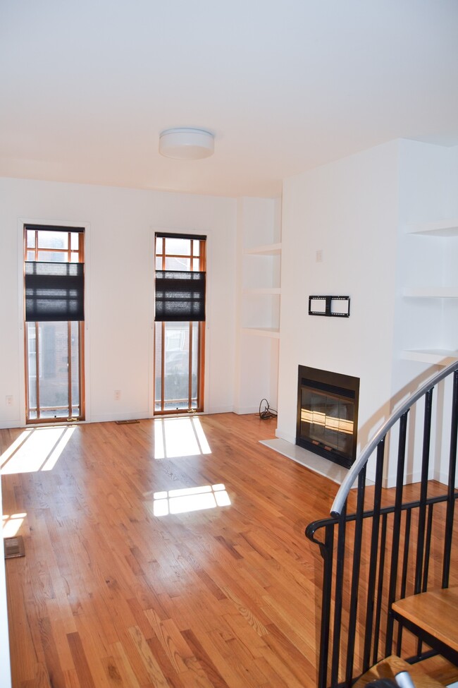 Second floor living room with built in shelving and 8 ft custom windows - 816 N Pennock St