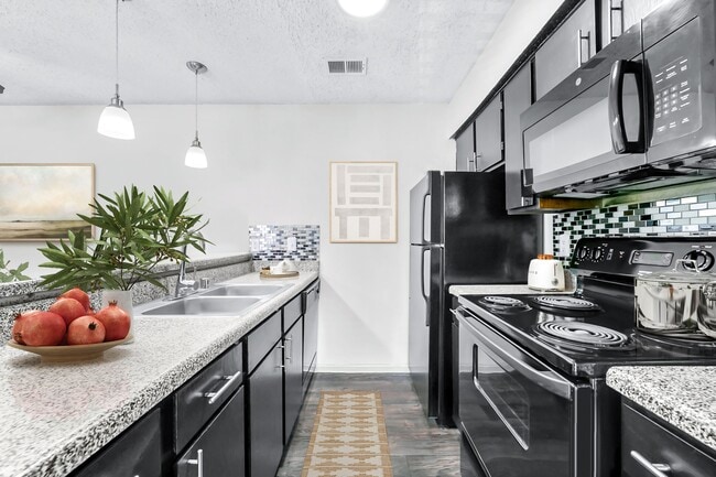 A1 Kitchen w/ Black Appliance Package & Backsplash - Vesper Apartments