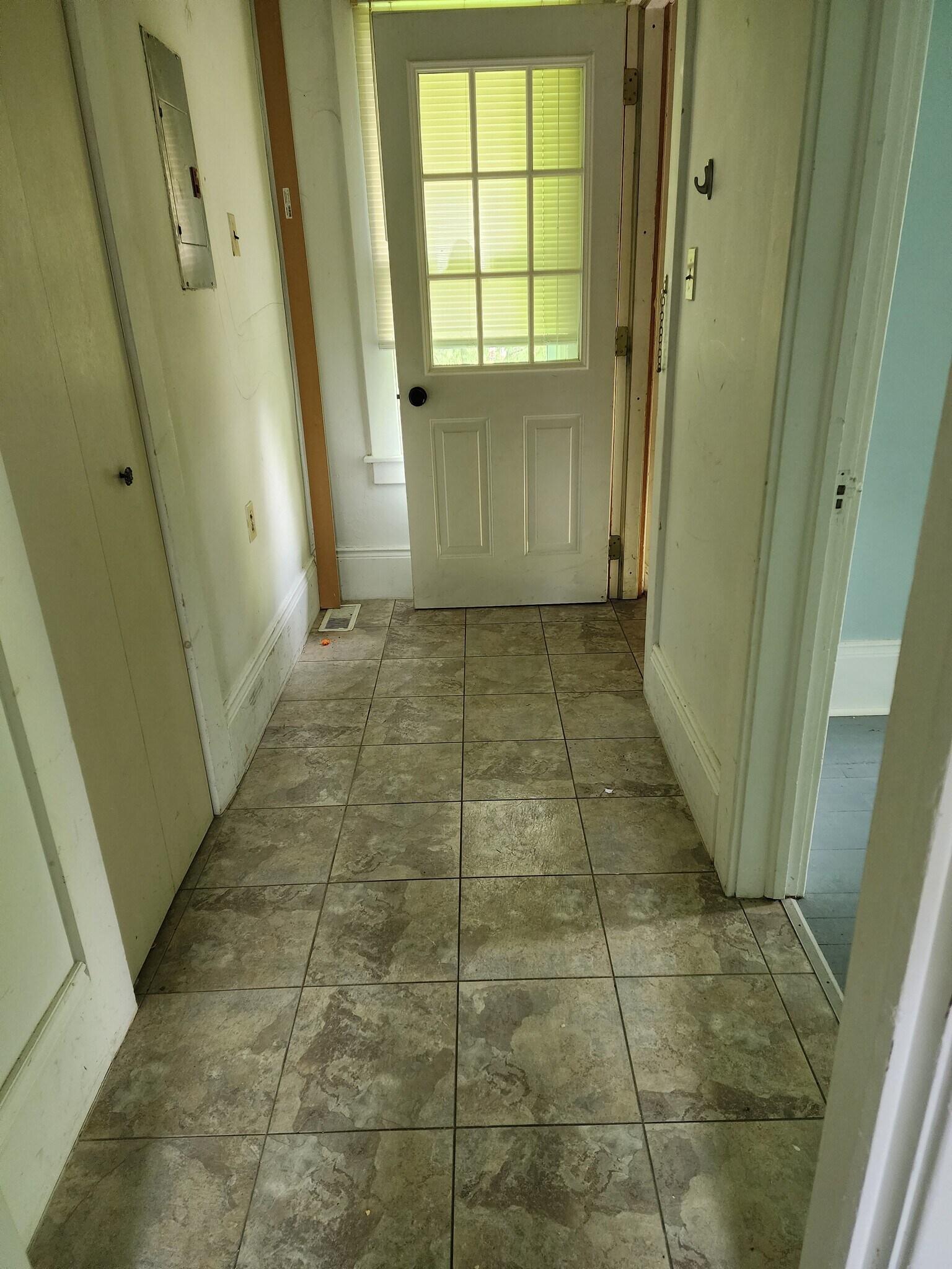 Apartment entry way with coat closet (this has all been painted bright white). - 89 S Main St
