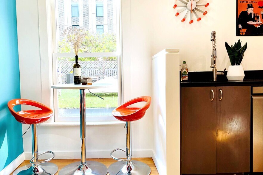 Kitchen has breakfast nook with small circular cafe table with two tall cafe chairs - 328 Harriet St