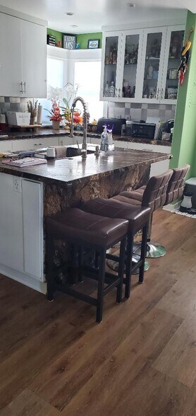 island counter with sink and area for eating - 1439 W El Segundo Blvd