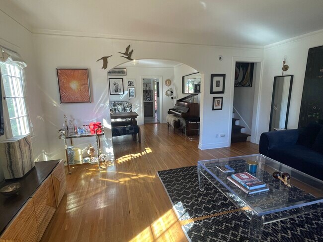 View from the main entrance (of the living room, dining room, kitchen entry, and stairwell. - 1501 Westerly Ter