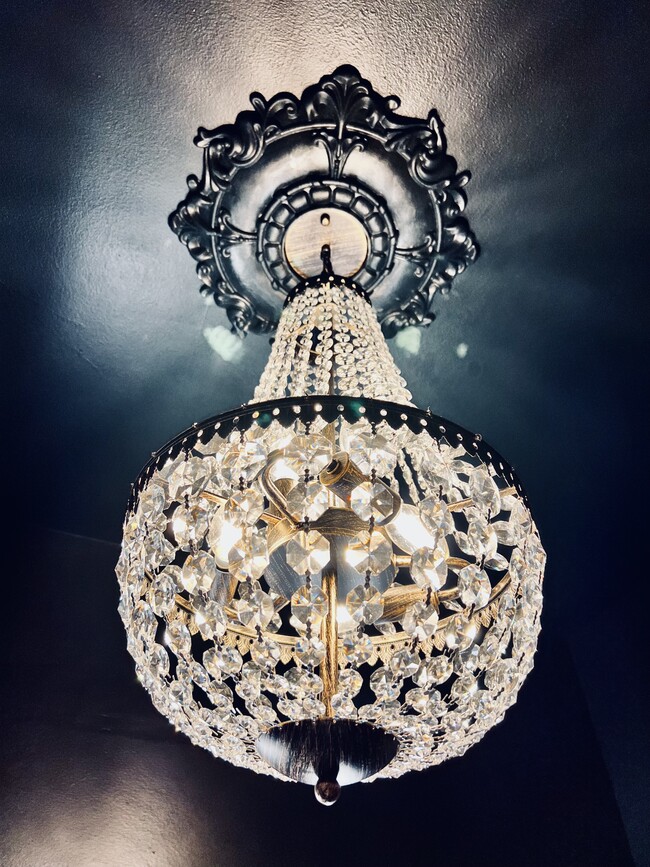 The custom chandelier as the focal point for the bathroom. - 2424 Stevens Ave