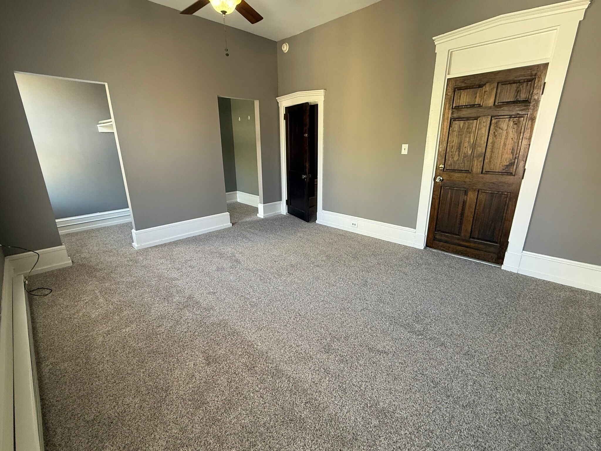 Bedroom 1 with double walk-in closets; door on right accesses building stairwell - 218 E Orange St