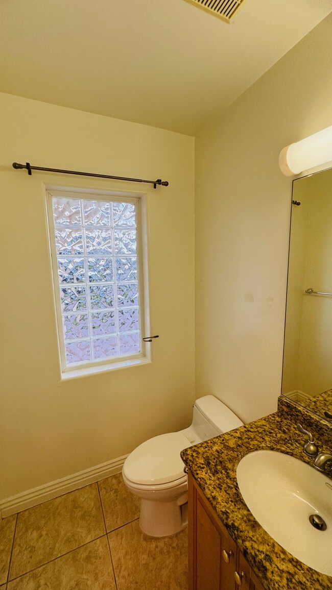 1/2 bathroom on the first floor for guests and convenience - 2107 Plant Ave