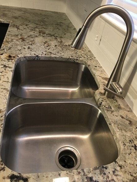 New granite, subway tile back-splash, Moen pull down sprayer faucet, and sink - 2400 Dijon Dr