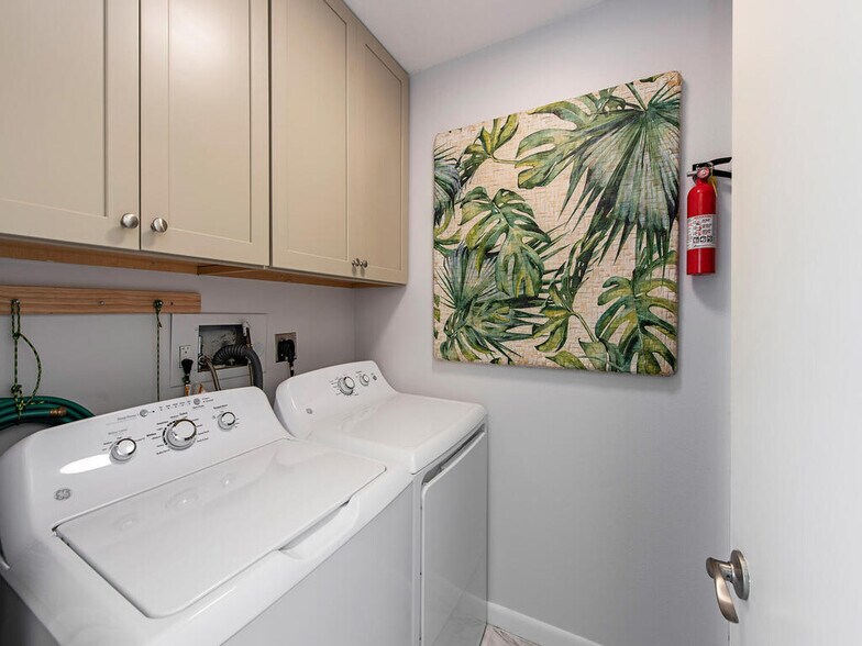 Laundry room with ample cabinet storage - 555 Park Shore Dr