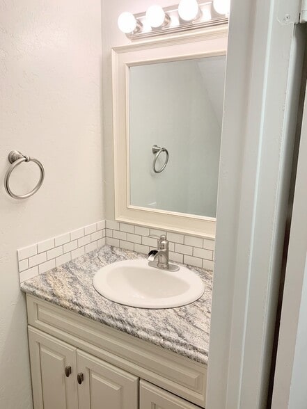 Half bath downstairs. This is *not* an actual picture of the property. This is a picture of an identical unit in the same complex with similar finishes. Actual photos will be uploaded after 4/1/21 when the new carpet is installed. - 1005 Willow Green Dr