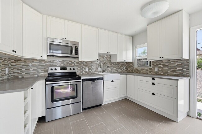 Building Photo - $2,140.95 -  2 bed, 1 bath located in Denver with a big backyard and In Unit Laundry!