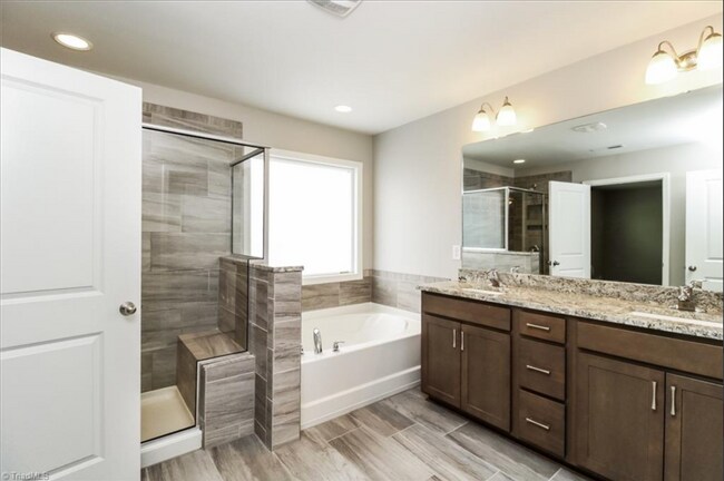 Building Photo - Impeccable maintenance-free 2 level 4 bedroom and 2.5 bath townhome in Greensboro