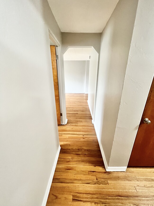 Step into this elegant hallway, leading to a spacious and modern living area. - The Birney Apartments