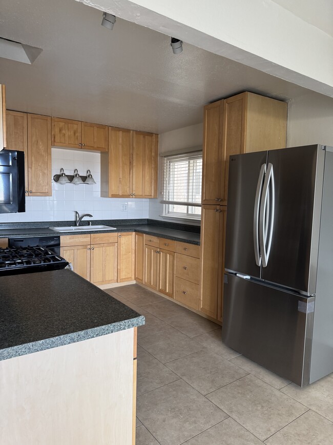 kitchen w/ new fridge - 7015 Trolleyway