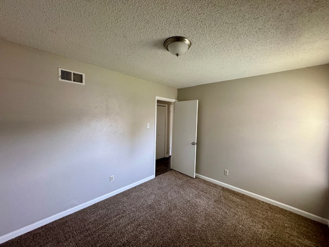 Building Photo - Charming 3BR/2BA Near Southwind | Soaring Vaulted Ceilings, Brick Fireplace & Fenced Yard