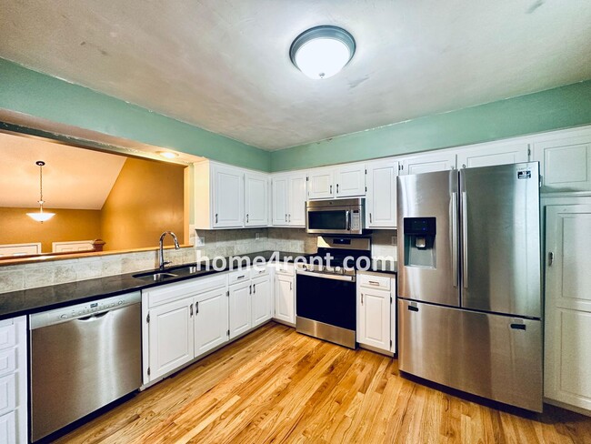 Building Photo - A Lovely Lenexa Home w/ Wood Floors Throughout, Updated Kitchen, Finished Basement and a Fenced Y...