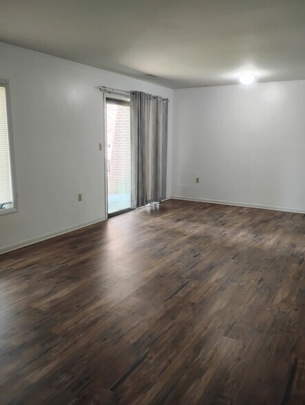 The living room shows the door to the patio. Private backyard. - 334 Shenandoah Cir