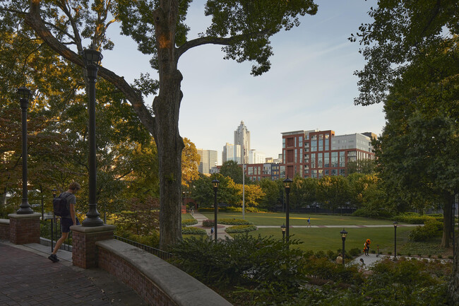 Experience the tranquility of urban living with this view of a serene park set against a modern skyline. - Inspire