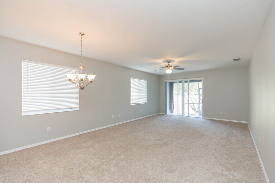Large great room (combined living room/dining room) with access to small lanai and view of pond/golf - 18135 Nassau Point Dr