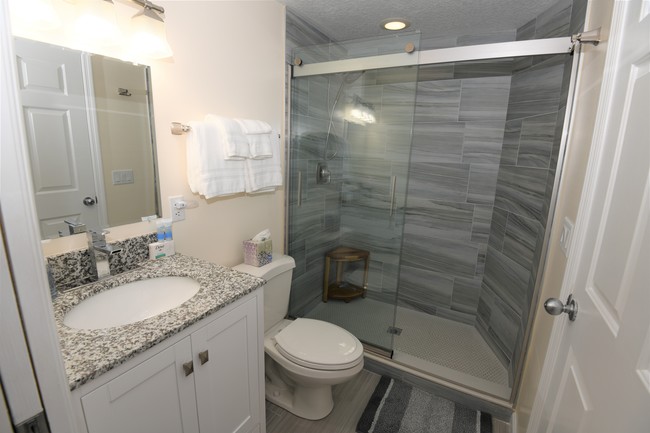 Luxuriously updated guest bathroom. - 5799 NE Island Cove Way