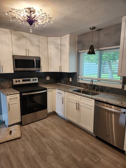 Beautifully temodeled kitchen with all newer stainless steel appliances - 8215 32nd Ave N