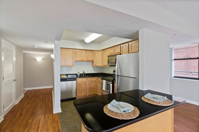 Two-bedroom apartment kitchen with stainless steel appliances and bar area - 1633 Q Apartments