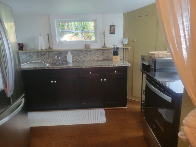 granite counter tops in kitchen and cherry cabinets - 3600 N Bay Homes Dr