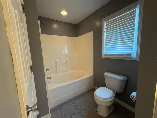 Building Photo - Spacious 4-Bedroom Sanctuary with Cozy Fireplace on Chimney Swift Drive!