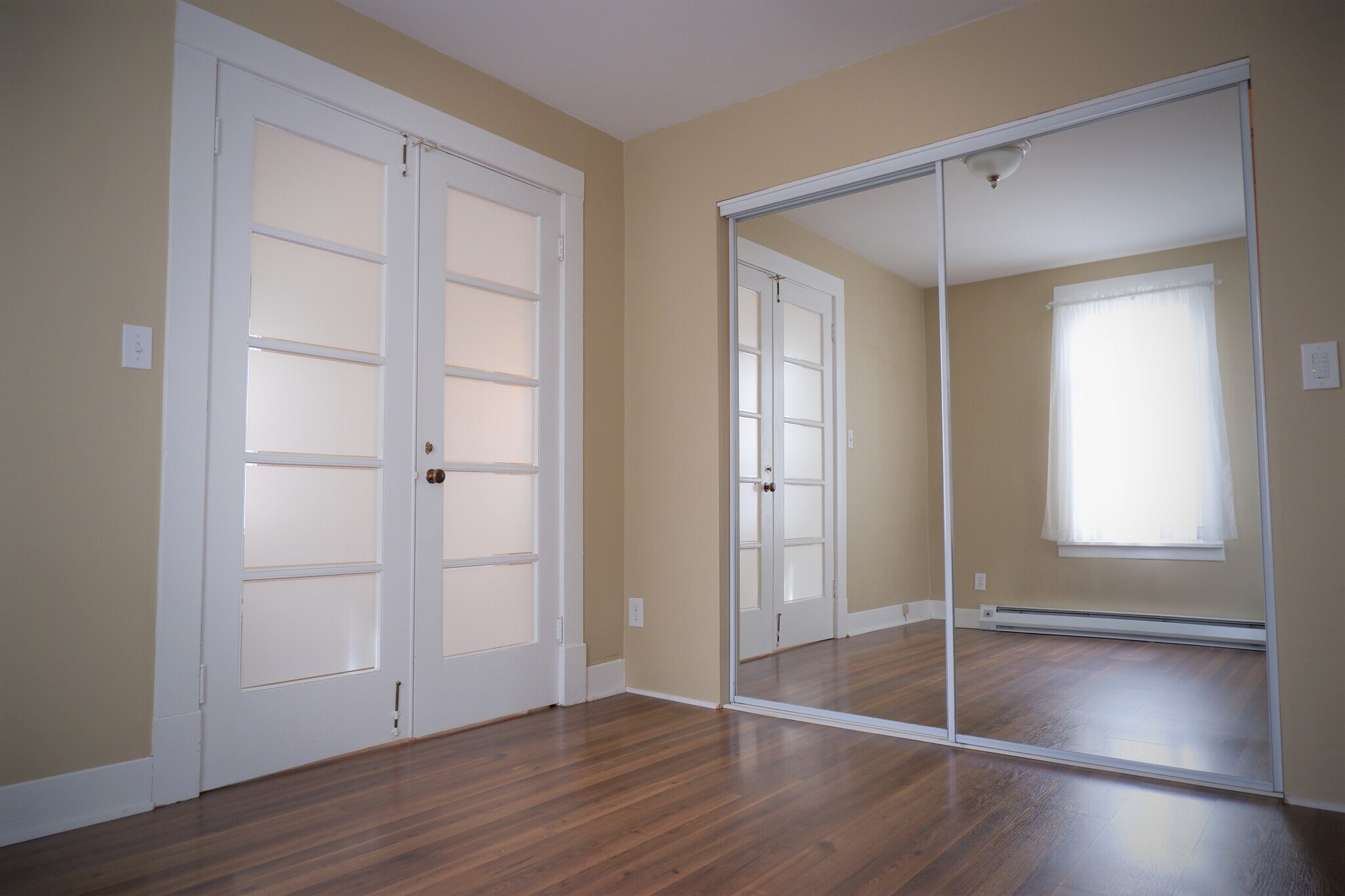 Main bedroom with mirrored closet doors (so you can see how good you look when you get dressed from your built-in closet space :) - 3517 E 32nd Ave