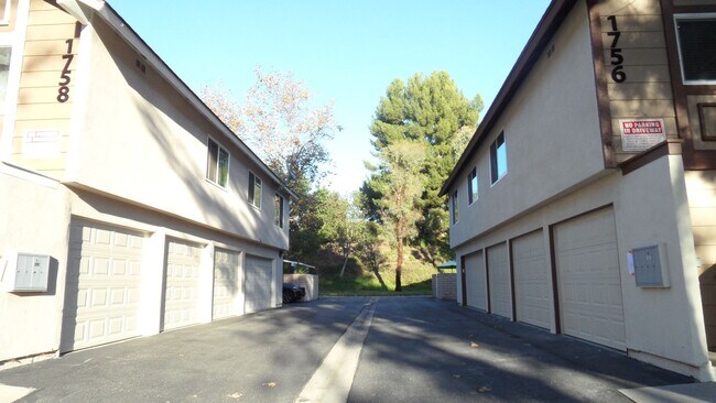 Building Photo - REMODELED 2BR; 1BA end unit condo w/ 1 car garage & 1 parking space