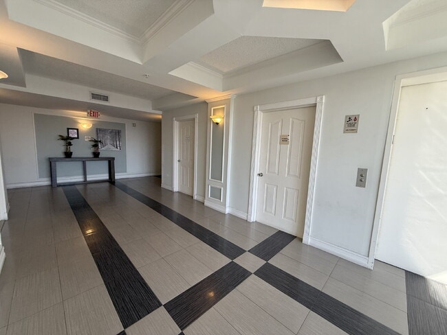 Building Photo - Rare 2/2 Corner Penthouse with Panoramic Lagoon Views from Every Room – Available Now!