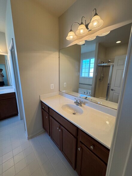 The spacious en-suite primary bathroom has TWO separate sink vanities - here is 1 of 2. - 44520 Gray Wolf St