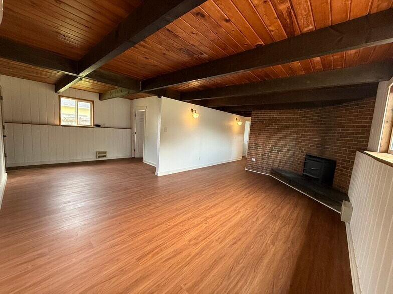 Family room facing laundry room, hallway to downstairs bath, master suite, and stairs to front door - 13016 16th St NE