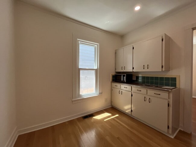 Building Photo - Charming Cottage with Hardwood Flooring, Modern Kitchen & Beautiful Outdoor Living Areas