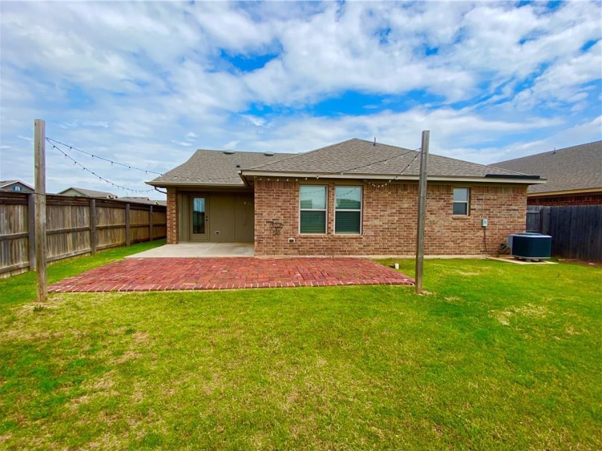 Backyard with extended pavers, outdoor lights, and pond view - 2452 NW 190th St