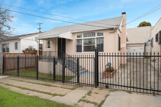 Picture from the street of the property. Entire property is enclosed and very private. Long driveway - 2108 E 23rd St