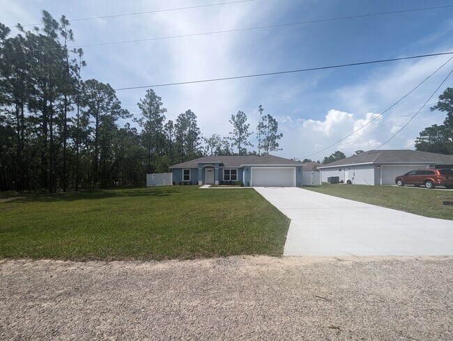 Building Photo - New 3/2/2 fenced home with Many Upgrades i...