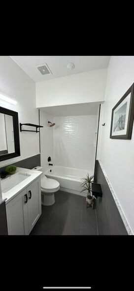 Marvel countertop bathroom with copper showerhead - 312 Poinsetta Dr