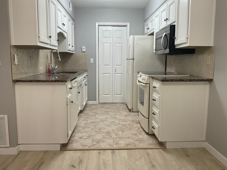 The laundry room is at the end of the kitchen - 12743 W 110th Ter