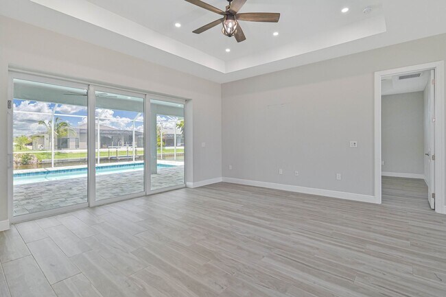 Building Photo - NOW AVAILABLE - Gorgeous Pool Home ~ NW Cape ~ 3 Car Garage ~ On Canal!