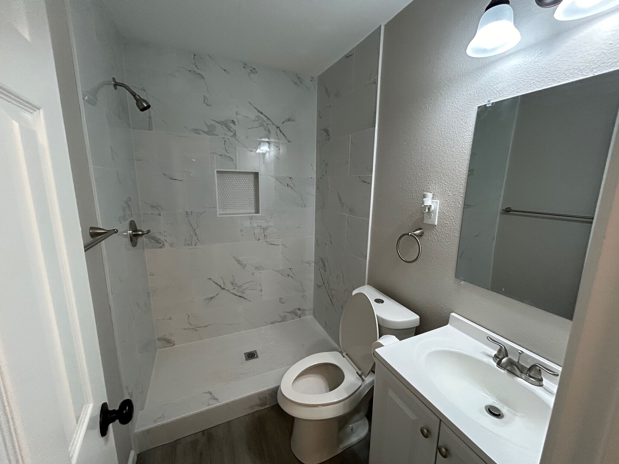 The Master bath has a walkin shower, new vanity and toilet. - 2245 E Overton Rd