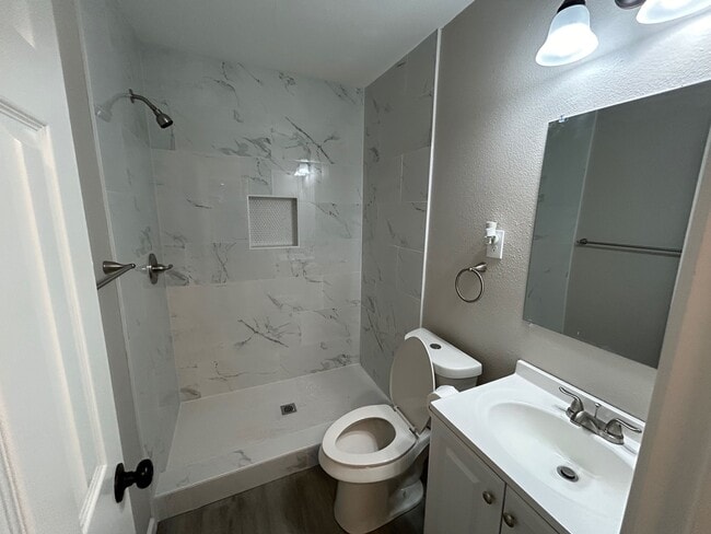 The Master bath has a walkin shower, new vanity and toilet. - 2245 E Overton Rd