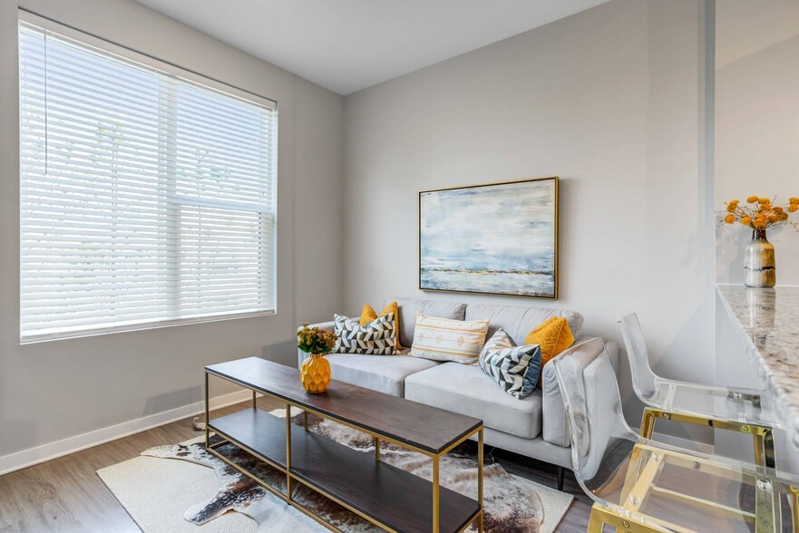 Inviting Living Room with Large Window - The Views of Music City Apartments