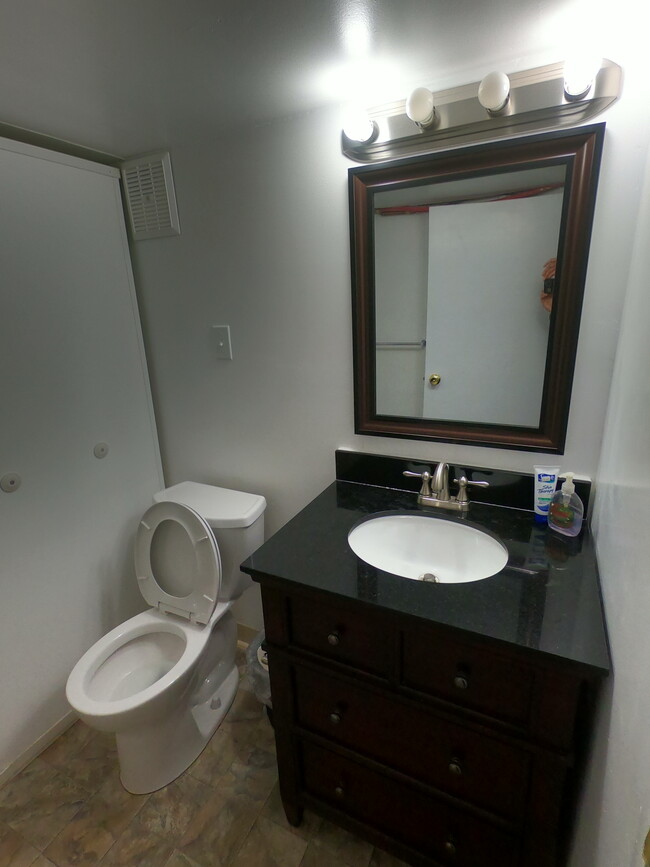 The beautiful stone vanity of the bathroom. - 303 Hanover St