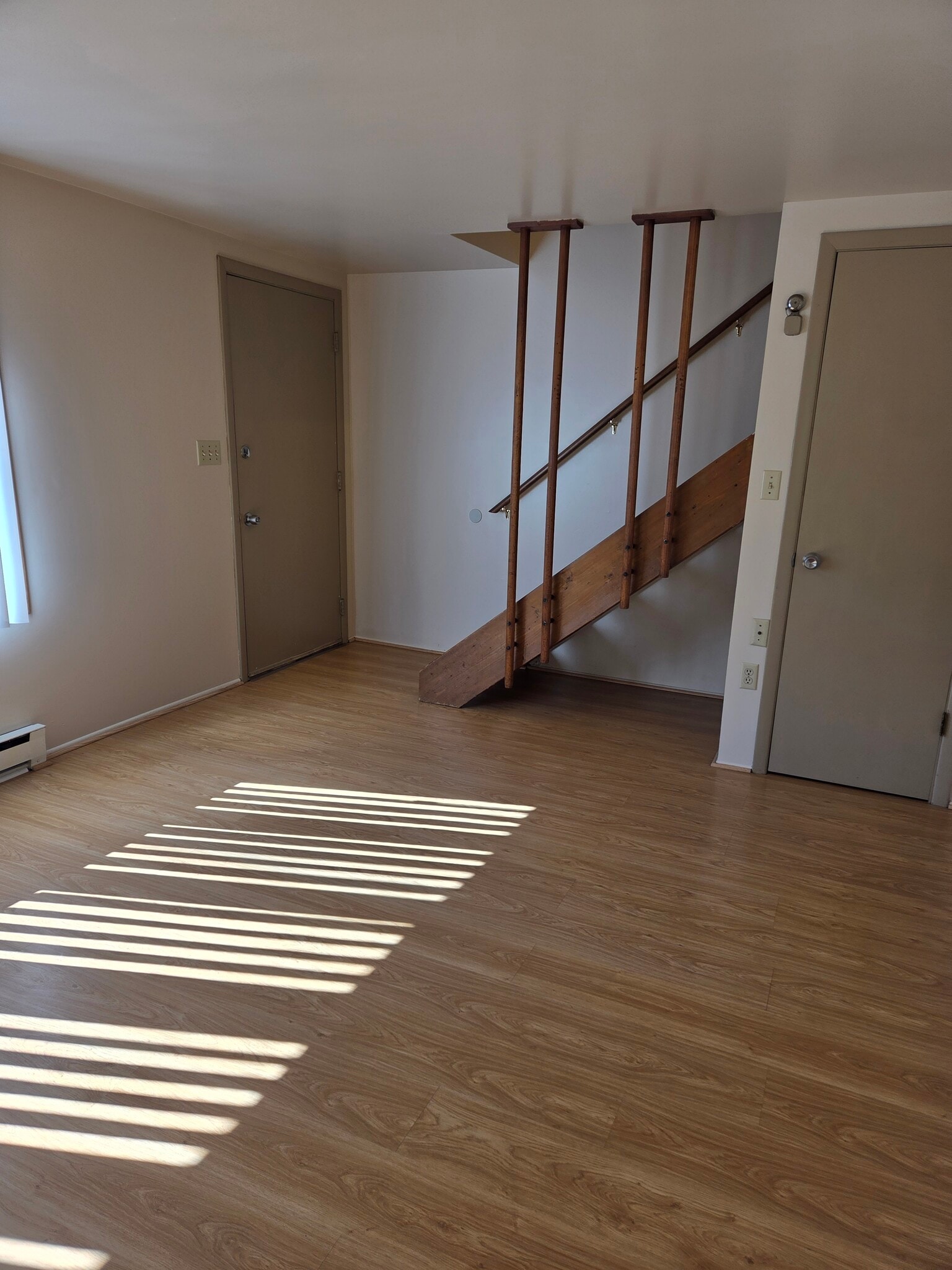 Sun streaks through the window blinds in the living room - 496 Mercer Rd