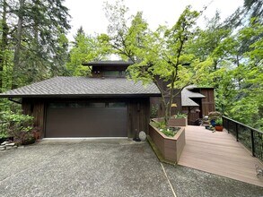 Building Photo - One-of-a-Kind Custom Home with Wall of Windows, Stone Fireplaces, Expansive Entertainment Space &...