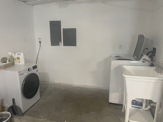 New washer, dryer, and laundry sink. - 767 SW Ravenswood Ln