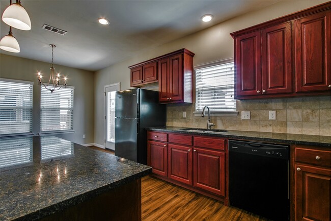 Kitchen- Cherry wood -Cabernet raised panel woodwork & Granite counters - 4917 Sanger Circle